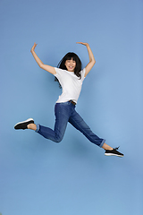 Image showing Portrait of young asian woman isolated on blue studio background