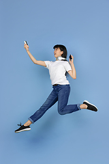 Image showing Portrait of young asian woman isolated on blue studio background