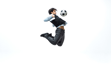 Image showing Man in office clothes playing football or soccer with ball on white background. Unusual look for businessman in motion, action. Sport, healthy lifestyle.