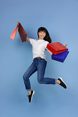 Image showing Portrait of young asian woman isolated on blue studio background