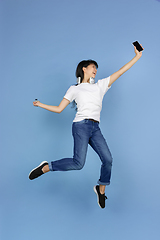 Image showing Portrait of young asian woman isolated on blue studio background