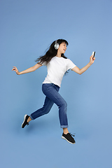 Image showing Portrait of young asian woman isolated on blue studio background