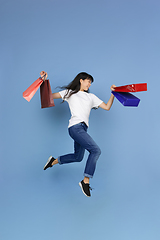 Image showing Portrait of young asian woman isolated on blue studio background