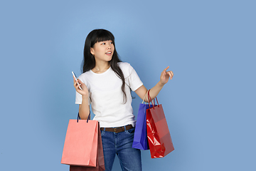 Image showing Portrait of young asian woman isolated on blue studio background