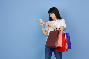 Image showing Portrait of young asian woman isolated on blue studio background