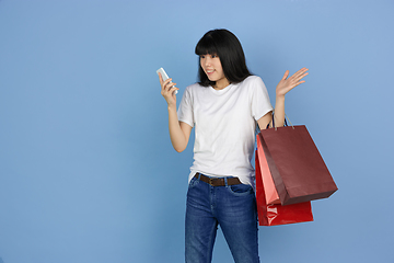 Image showing Portrait of young asian woman isolated on blue studio background