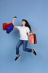 Image showing Portrait of young asian woman isolated on blue studio background