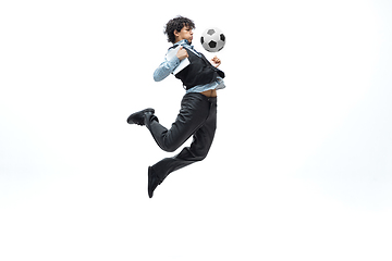 Image showing Man in office clothes playing football or soccer with ball on white background. Unusual look for businessman in motion, action. Sport, healthy lifestyle.