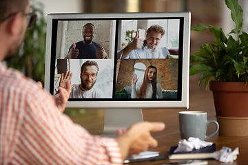 Image showing Remote meeting. Man working from home during coronavirus or COVID-19 quarantine, remote office concept.