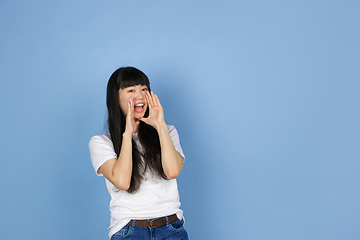 Image showing Portrait of young asian woman isolated on blue studio background