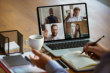 Image showing Remote meeting. Man working from home during coronavirus or COVID-19 quarantine, remote office concept.