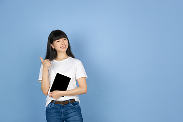 Image showing Portrait of young asian woman isolated on blue studio background