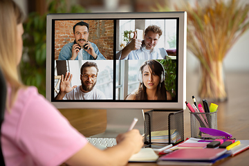 Image showing Remote meeting. Woman working from home during coronavirus or COVID-19 quarantine, remote office concept.