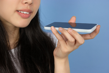 Image showing Portrait of young asian woman isolated on blue studio background