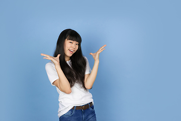 Image showing Portrait of young asian woman isolated on blue studio background