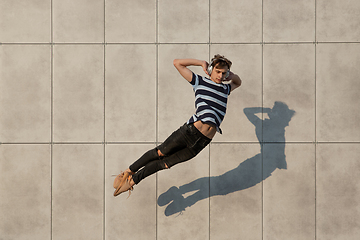 Image showing Jumping young buinessman in front of buildings, on the run in jump high