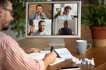 Image showing Remote meeting. Man working from home during coronavirus or COVID-19 quarantine, remote office concept.