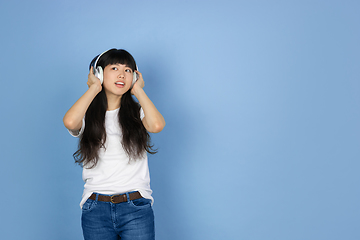 Image showing Portrait of young asian woman isolated on blue studio background