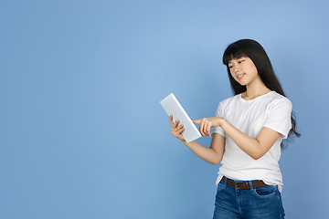 Image showing Portrait of young asian woman isolated on blue studio background