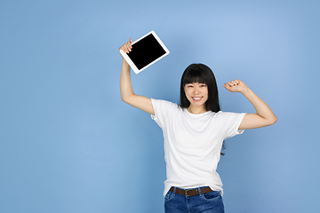 Image showing Portrait of young asian woman isolated on blue studio background