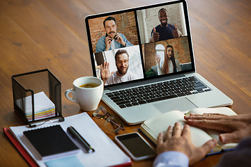 Image showing Remote meeting. Man working from home during coronavirus or COVID-19 quarantine, remote office concept.