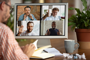 Image showing Remote meeting. Man working from home during coronavirus or COVID-19 quarantine, remote office concept.