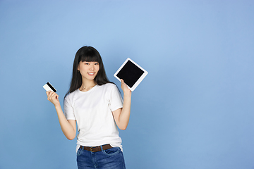 Image showing Portrait of young asian woman isolated on blue studio background