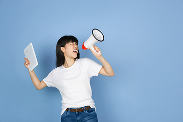 Image showing Portrait of young asian woman isolated on blue studio background