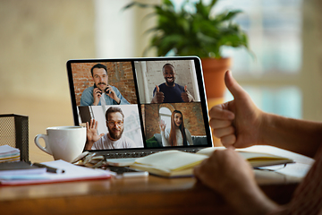 Image showing Remote meeting. Man working from home during coronavirus or COVID-19 quarantine, remote office concept.