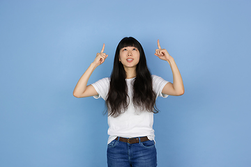 Image showing Portrait of young asian woman isolated on blue studio background