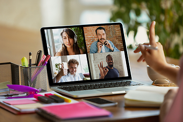 Image showing Remote meeting. Woman working from home during coronavirus or COVID-19 quarantine, remote office concept.