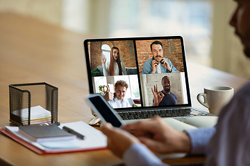 Image showing Remote meeting. Man working from home during coronavirus or COVID-19 quarantine, remote office concept.