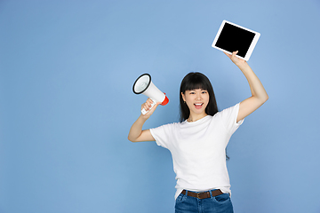 Image showing Portrait of young asian woman isolated on blue studio background