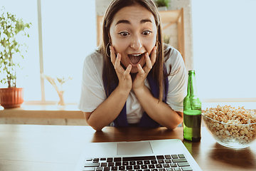 Image showing Excited football fan watching sport match at home, remote support of favourite team during coronavirus pandemic outbreak