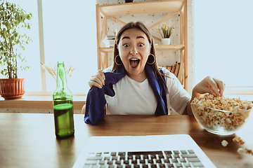 Image showing Excited football fan watching sport match at home, remote support of favourite team during coronavirus pandemic outbreak