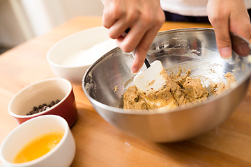 Image showing Woman mixing the dough for making cookies