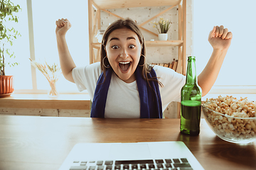 Image showing Excited football fan watching sport match at home, remote support of favourite team during coronavirus pandemic outbreak