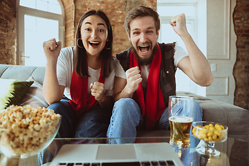 Image showing Excited football fans watching sport match at home, remote support of favourite team during coronavirus pandemic outbreak