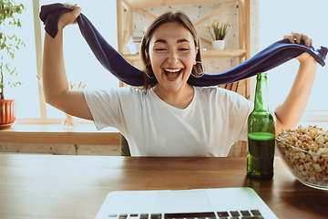 Image showing Excited football fan watching sport match at home, remote support of favourite team during coronavirus pandemic outbreak