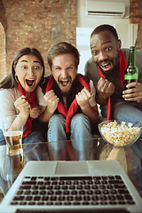 Image showing Excited football fans watching sport match at home, remote support of favourite team during coronavirus pandemic outbreak