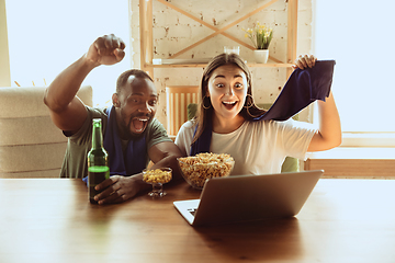 Image showing Excited football fans watching sport match at home, remote support of favourite team during coronavirus pandemic outbreak