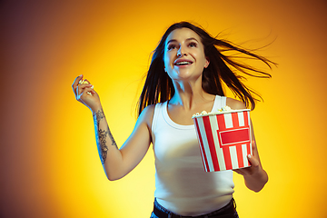 Image showing Portrait of young caucasian woman isolated on gradient yellow studio background