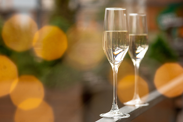 Image showing Glasses of sparkling champagne, close up. Warm colored. Celebration event, holidays, drinks concept