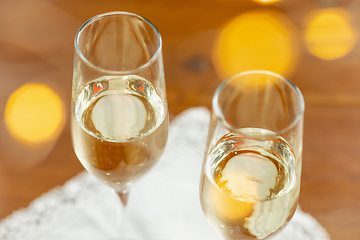 Image showing Glasses of sparkling champagne, close up. Warm colored. Celebration event, holidays, drinks concept