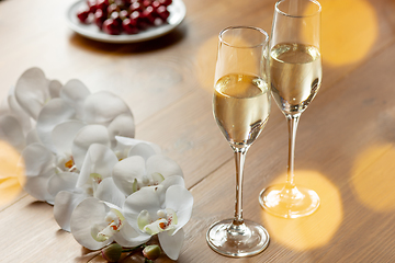Image showing Glasses of sparkling champagne, close up. Warm colored. Celebration event, holidays, drinks concept