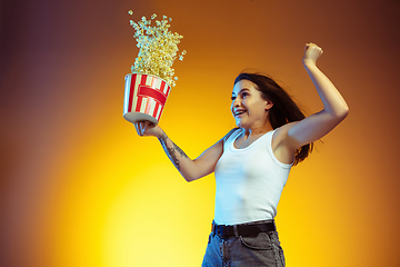 Image showing Portrait of young caucasian woman isolated on gradient yellow studio background