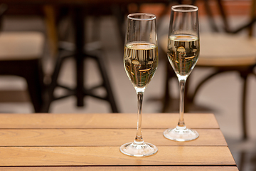 Image showing Glasses of sparkling champagne, close up. Warm colored. Celebration event, holidays, drinks concept