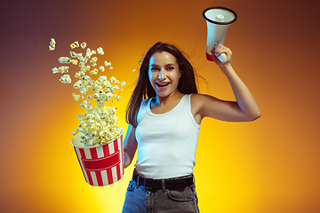 Image showing Portrait of young caucasian woman isolated on gradient yellow studio background