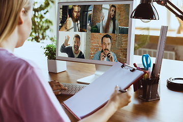 Image showing Remote meeting. Woman working from home during coronavirus or COVID-19 quarantine, remote office concept.