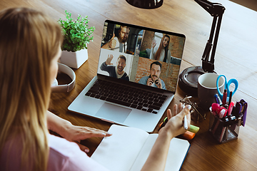 Image showing Remote meeting. Woman working from home during coronavirus or COVID-19 quarantine, remote office concept.